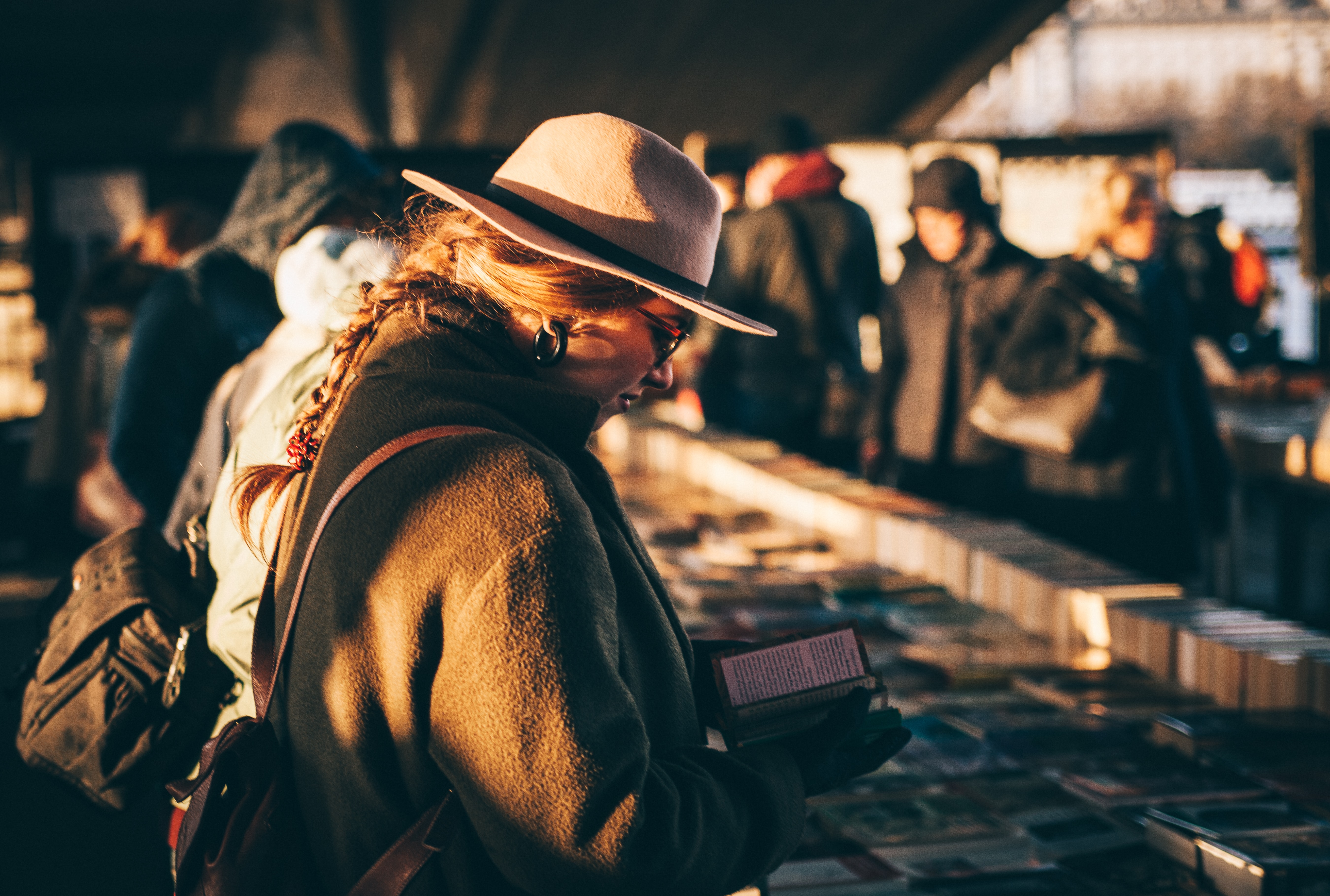 Frau guckt sich Bücher und vintage Sachen auf dem Flohmarkt