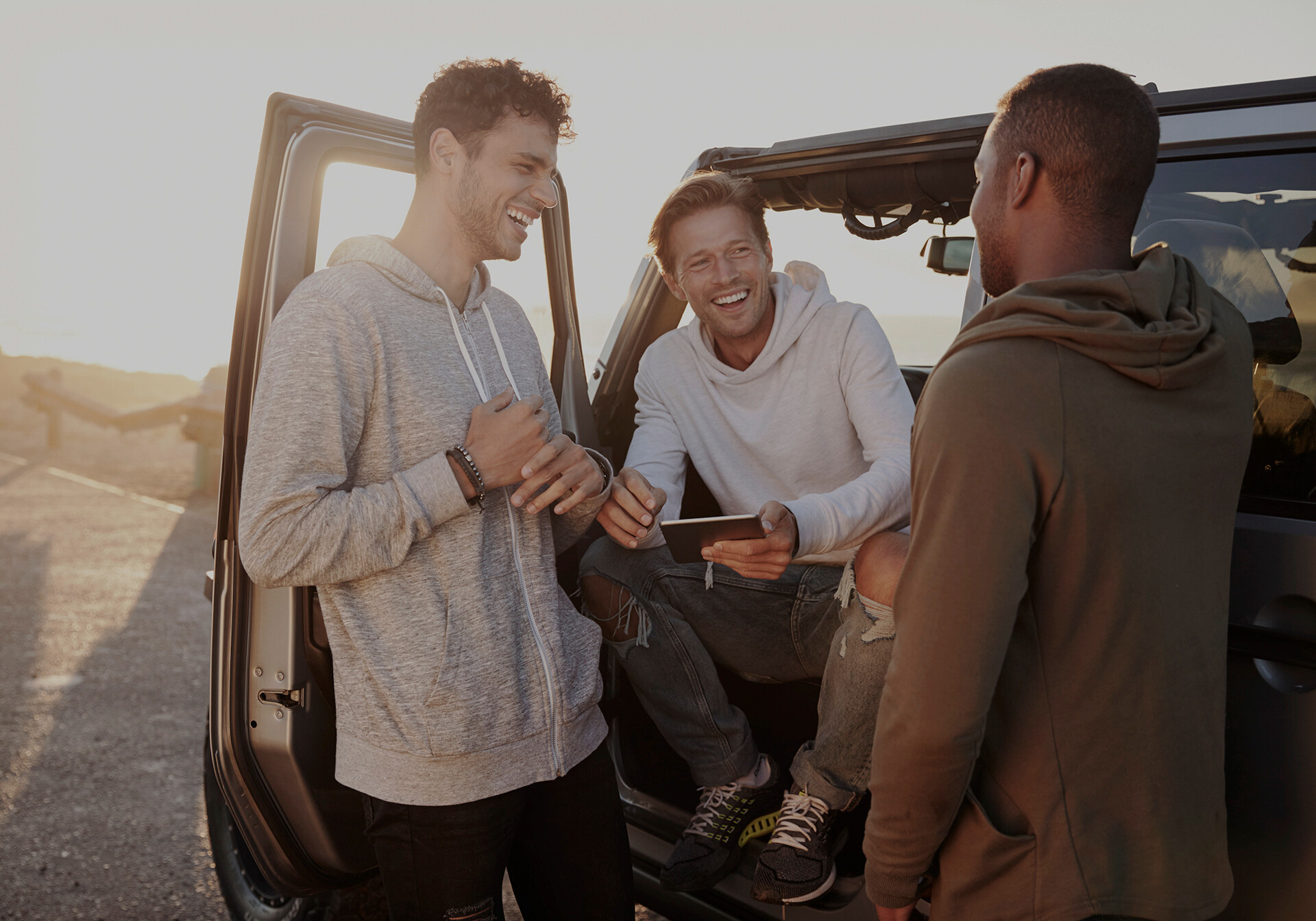 Three guys laughing in a car