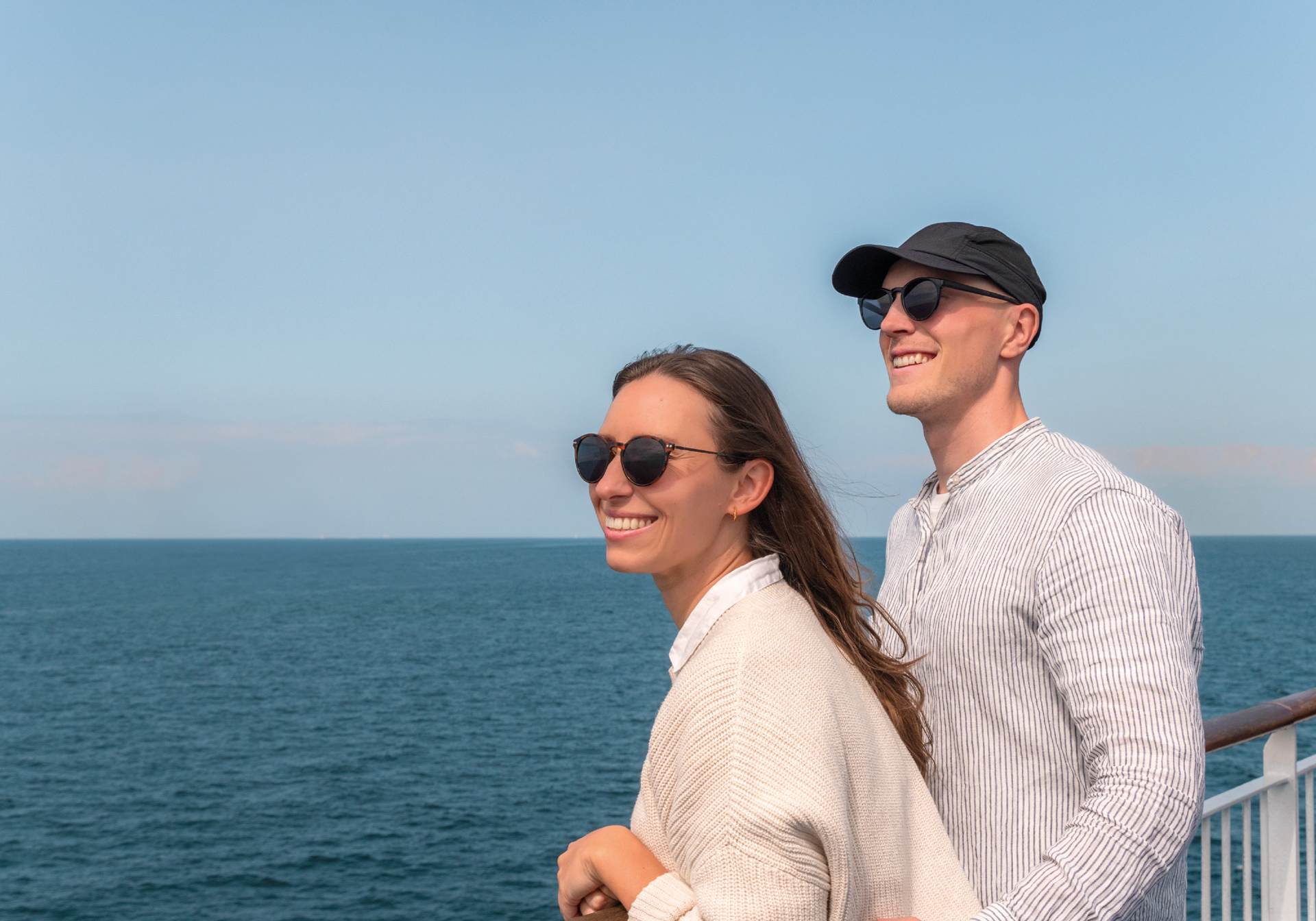 Your couple on a ferry deck overlooking the ocean