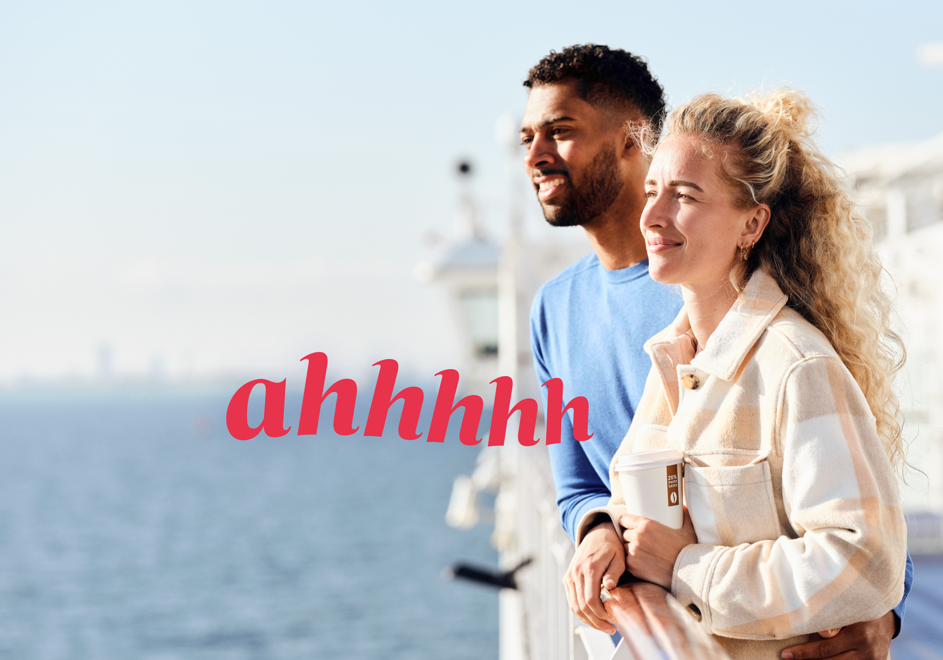Couple on the ferry deck overlooking the ocean