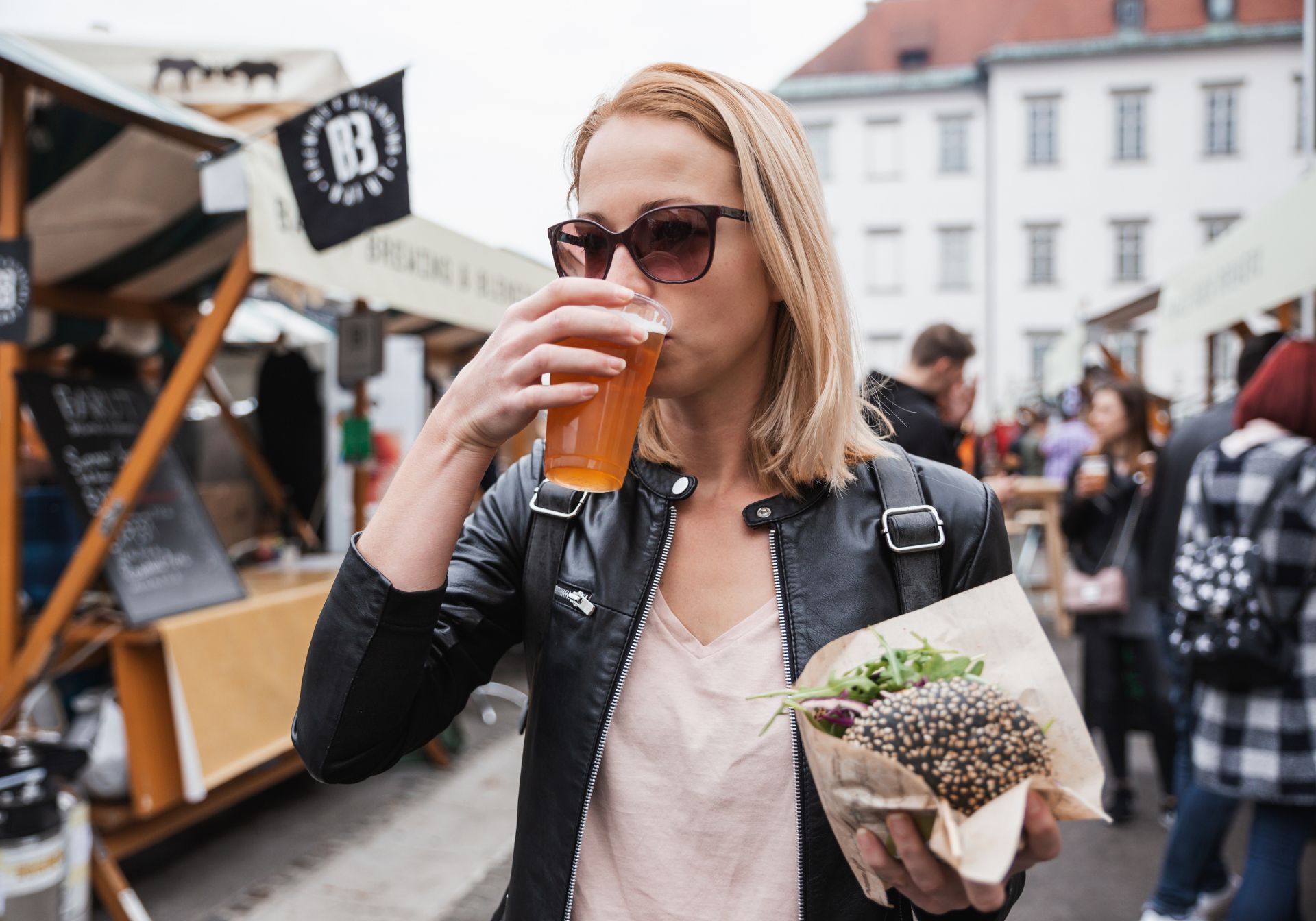 Woman drinks beer at a festival